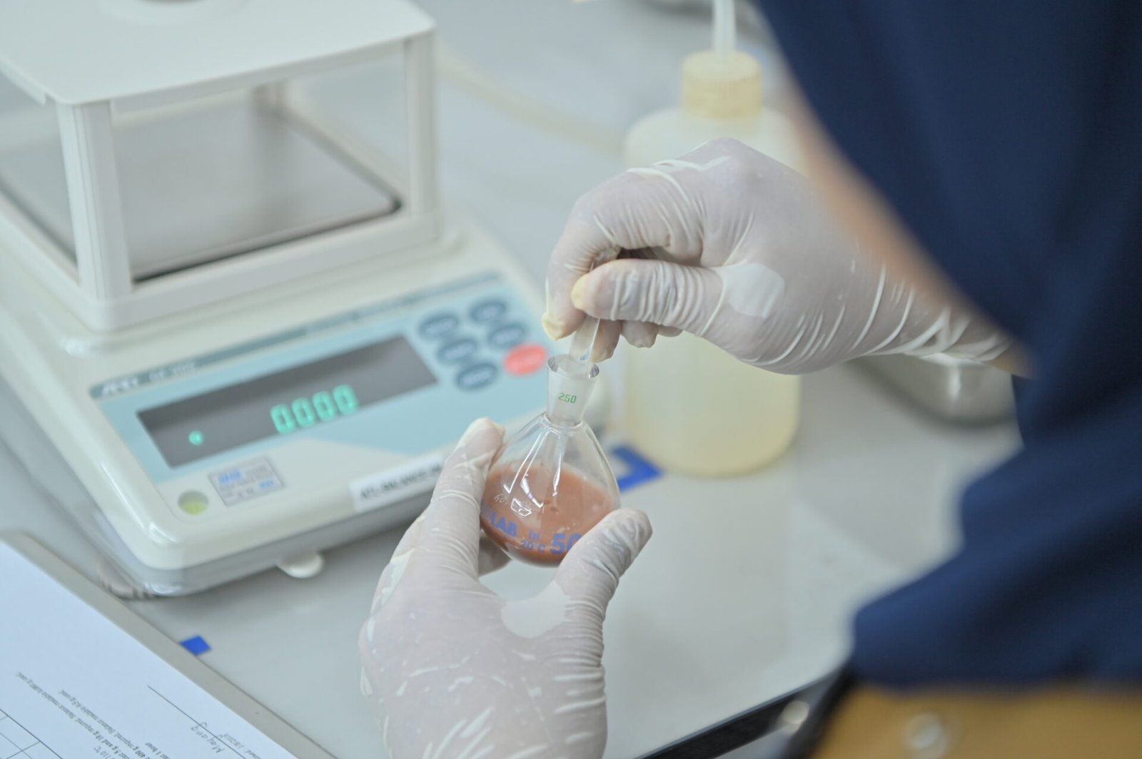ARCHITEST technician preparing a laboratory sample